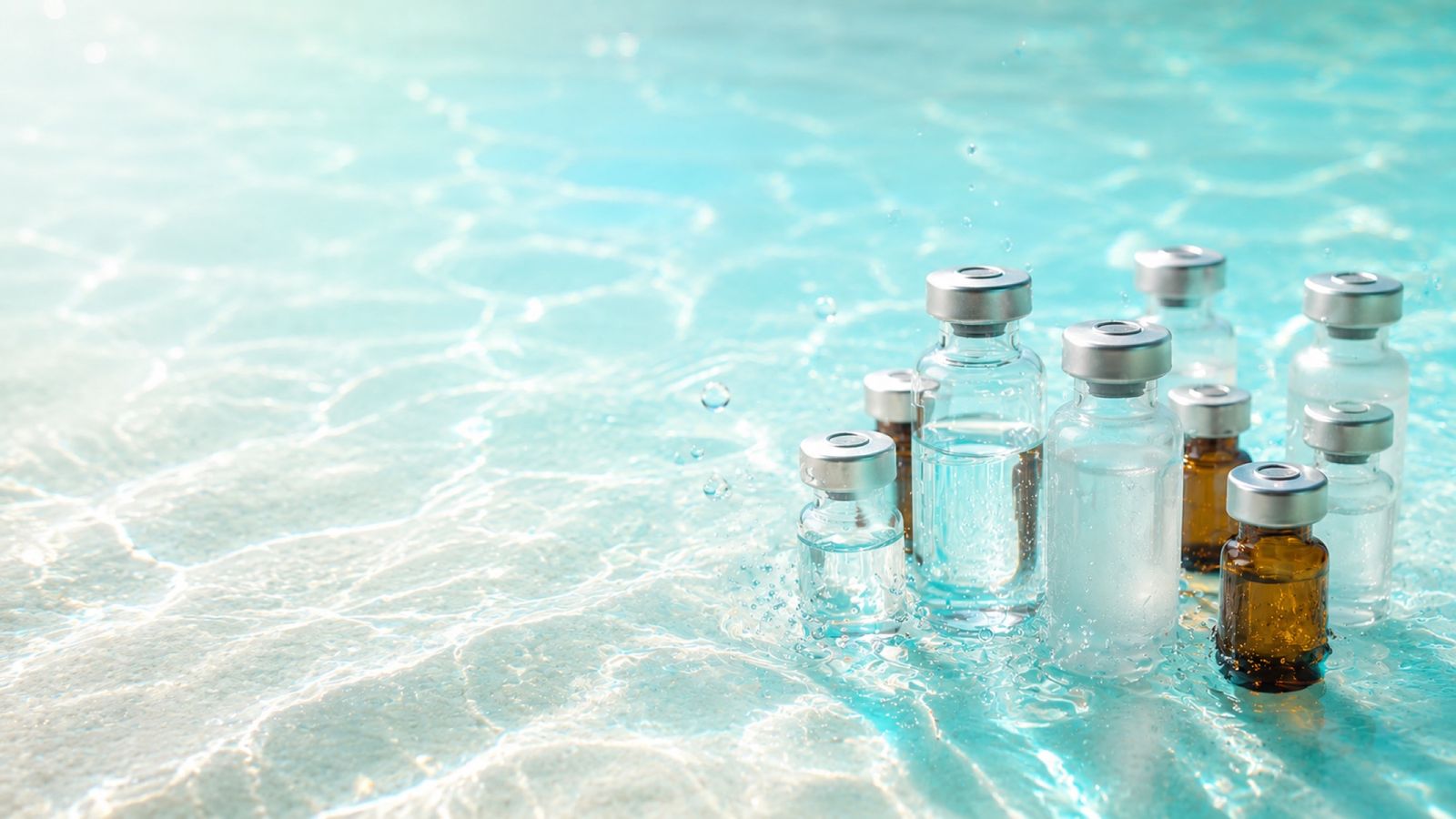 Lab-tested research peptide vials in bright aquatic light
